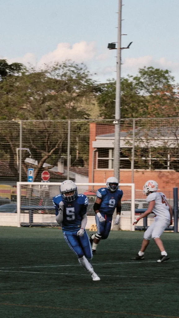 Vertical action shot of a Bufals player running on offense, highlighting speed and determination on the field.