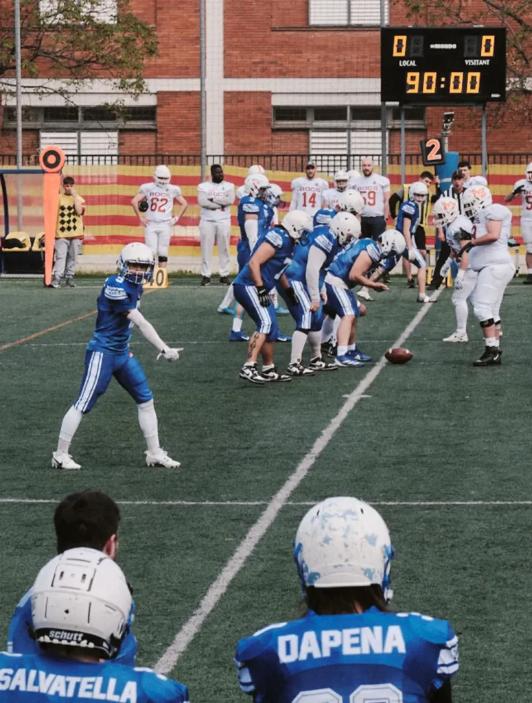 Wide angle shot of the two American football teams lining up at the line of scrimmage before the snap, focused on the Bufals team.