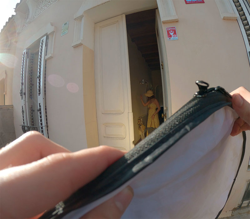 Behind the scenes image showing the crew setting up lighting equipment outside the entrance of a house