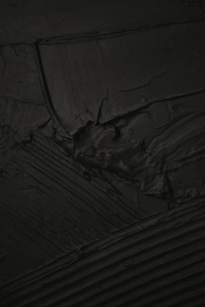 Abstract textured wall art close-up in black, highlighting modern minimalist design and artistic home decor product photography