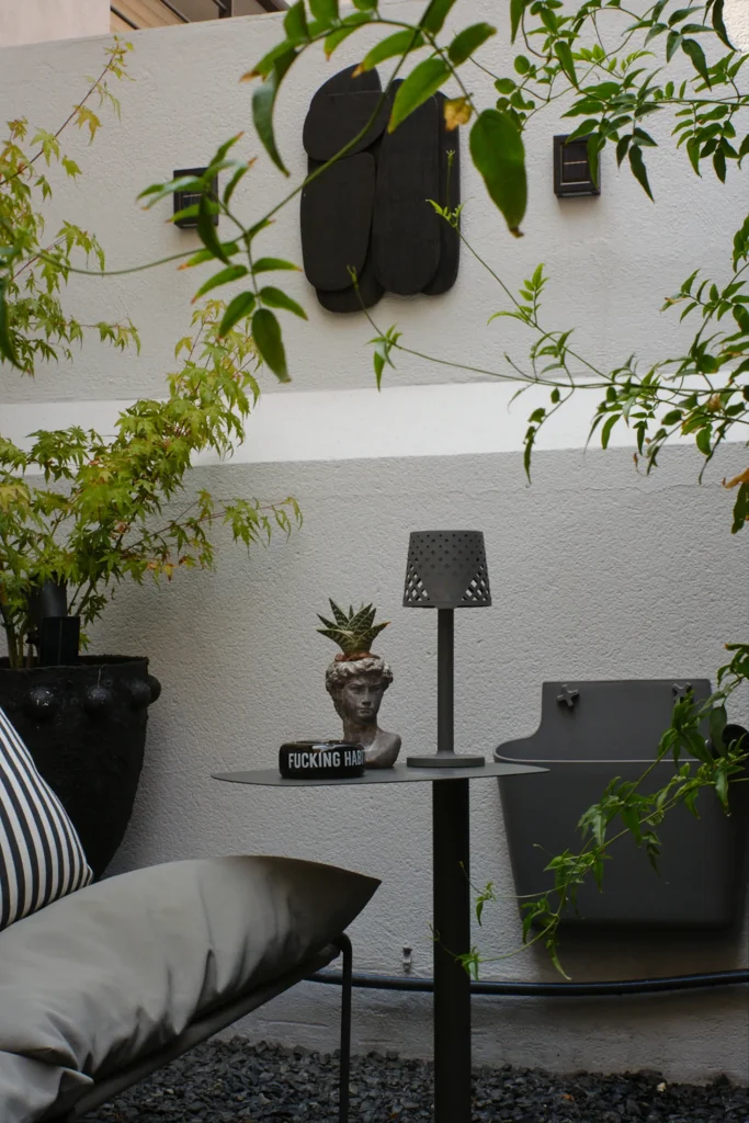 Detailed minimalist outdoor patio design photography, showcasing modern garden decor, elegant planters, and atmospheric lighting for exterior living spaces