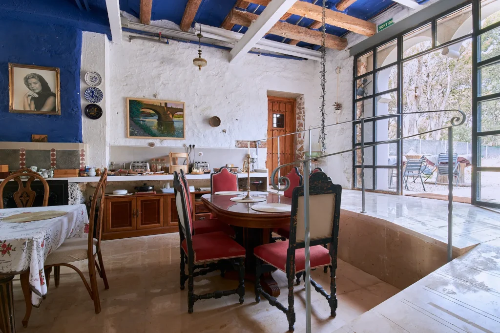 High-end interior photography of a luxury hotel room at Castell Granadella, showcasing minimalist design, natural lighting, and lifestyle detail.