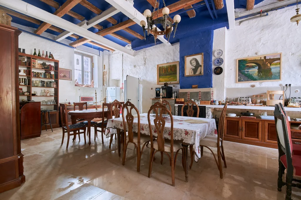 Lifestyle photography of a hotel patio/terrace at Castell Granadella, capturing the exclusive ambiance, rustic stone, and Mediterranean views