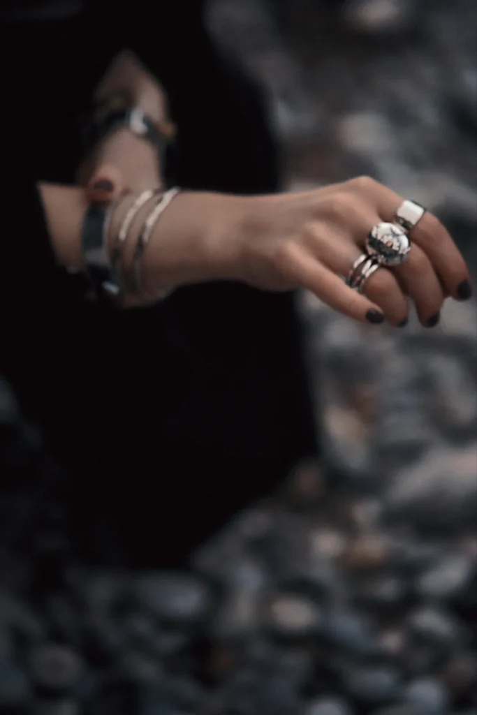 Fashion-focused portrait of a woman on a Mallorcan beach, utilizing the movement of the dress and the dynamic coastal setting.