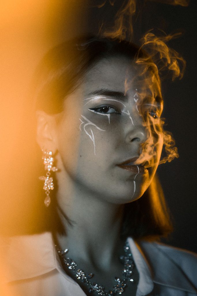 Striking avant-garde beauty portrait with stylized makeup and luxury jewellery, demonstrating expertise in high-concept fashion photography