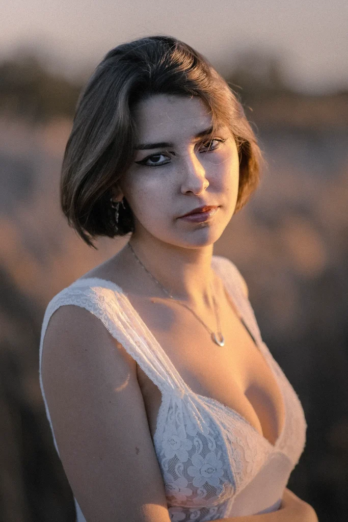 Unique location boudoir fashion shot of a woman in the aisle of a train car, capturing a dynamic pose and the architectural lines of the setting.