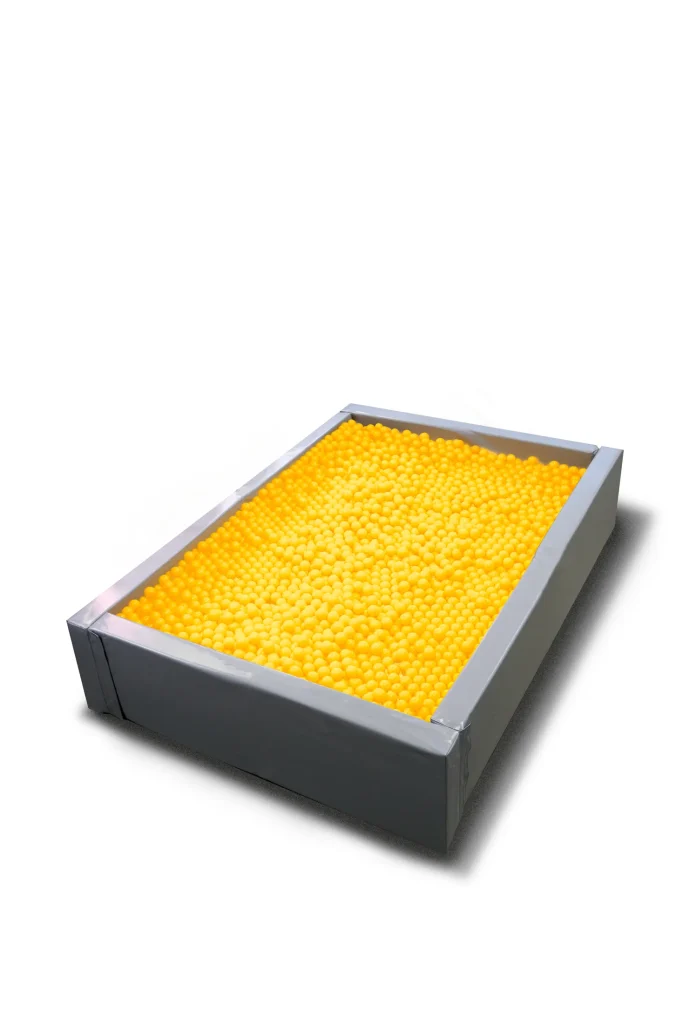 Large rectangular pit filled entirely with bright yellow plastic balls, ready for an experiential event activation or photo op.
